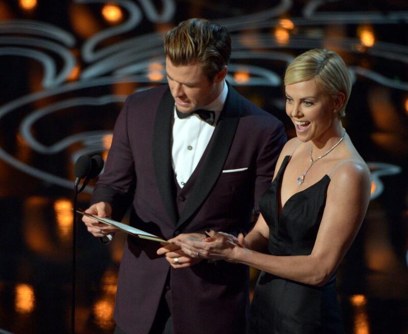 Chris Hemsworth, left, and Charlize Theron present an award. 