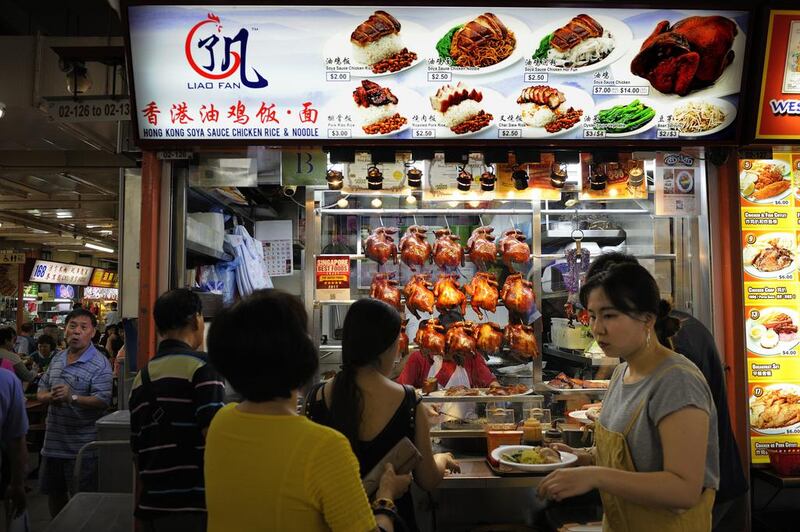 Customers queueing for their food at the one-Michelin star street food stall Liao Fan Hong Kong Soya Sauce Chicken Noodle & Rice at Chinatown food centre in Singapore on May 2, 2017. Munshi Ahmed for The National