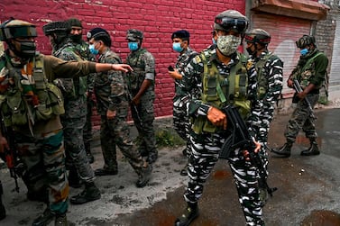 Security personnel gather near the site where suspected militants fired at police near Nowgam bypass in Srinagar on August 14, 2020. At least two policemen were killed and another got injured after militants allegedly opened fire on police party in Nowgam area, local media reported on August 14. / AFP / Tauseef MUSTAFA