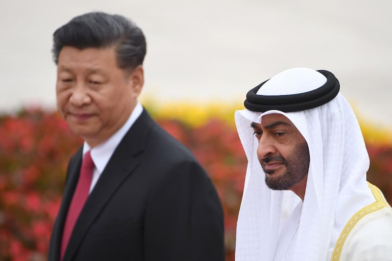 Abu Dhabi Crown Prince Mohammed bin Zayed (R) walks with China's President Xi Jinping during a welcoming ceremony outside the Great Hall of the People in Beijing on July 22, 2019. / AFP / GREG BAKER
