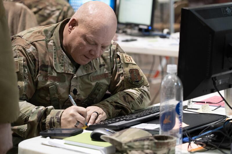 A West Virginia National Guardsman takes notes inside the state's joint inter-agency task force for the Covid-19 Vaccine. Willy Lowry / The National