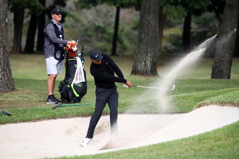 Tiger Woods hits out from a bunker on the 11th hole. Getty