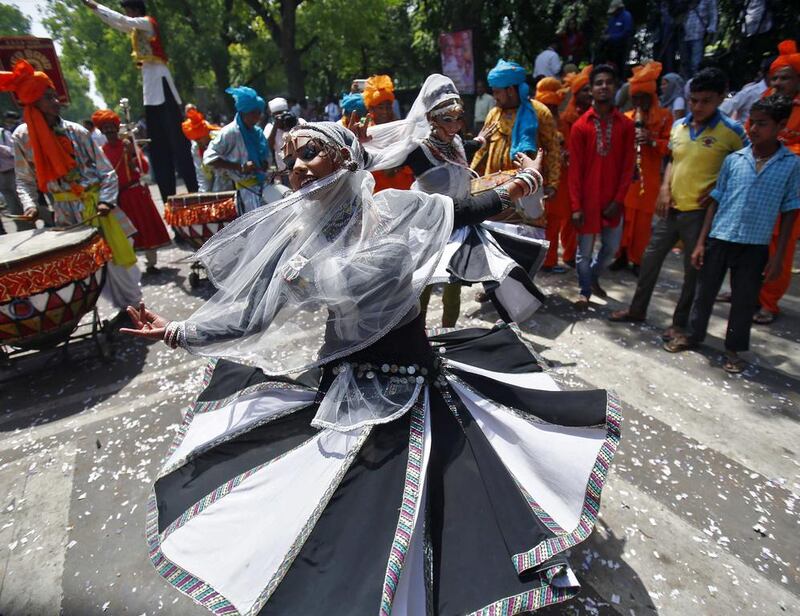 A supporter of the BJP dances outside the party headquarters in New Delhi. Anindito Mukherjee / Reuters / May 16, 2014