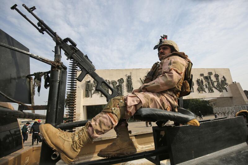 An Iraqi soldier sits atop a military vehicle in central Baghdad's Tahrir square, during celebrations marking the founding of the country's army. AFP