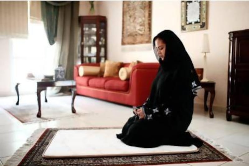 Emirati Ghada Zakari prays at her Dubai home on a special prayer mat that helps reduce pressure points on the body and absorbs weight. Sarah Dea / The National