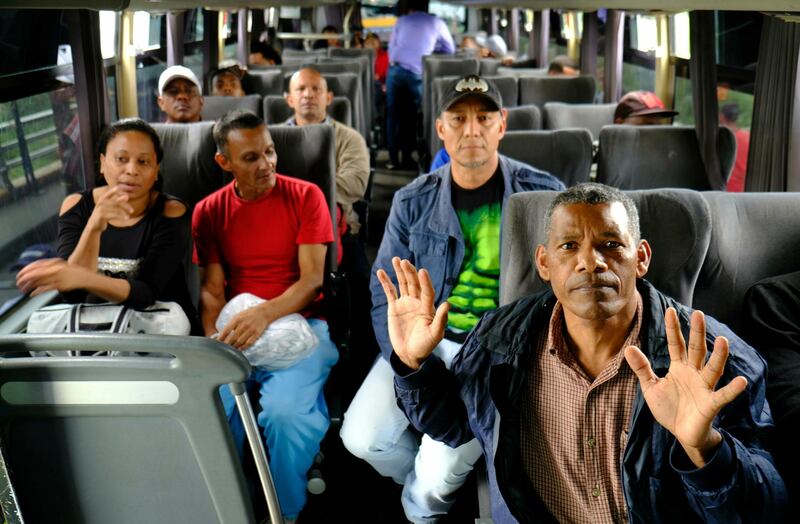 Colombian citizens deported from Venezuela sit in a bus, at the Simon Bolivar international bridge, on the Venezuela â€“ Colombia border, Saturday, June 29, 2019. Venezuela's President Nicolas Maduro released 59 Colombians that rights groups said were arbitrarily detained in 2016. The United Nations immediately praised the move, which came days after an important visit to Caracas by its top human rights official, Michelle Bachelet, saying it expects more prisoner releases in the coming days. (AP Photo/Ferley Ospina)