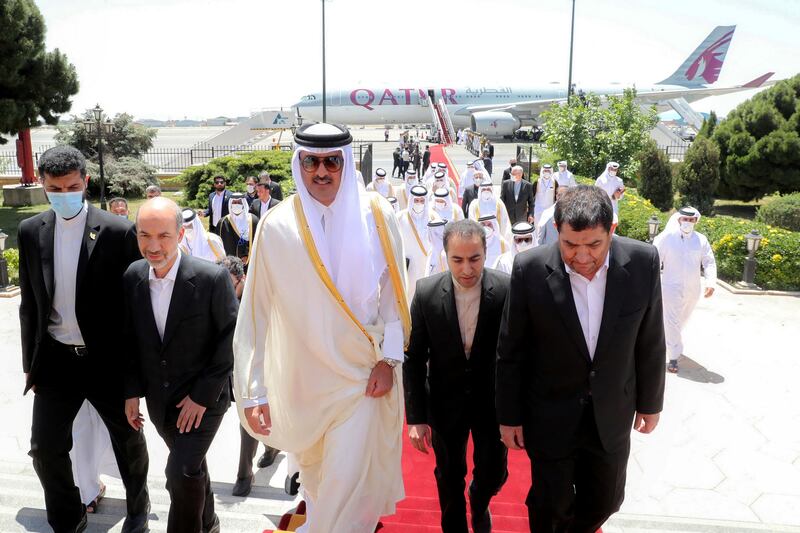 Mr Mokhber welcomes Sheikh Tamim upon his arrival at Mehrabad Airport in Tehran. Reuters