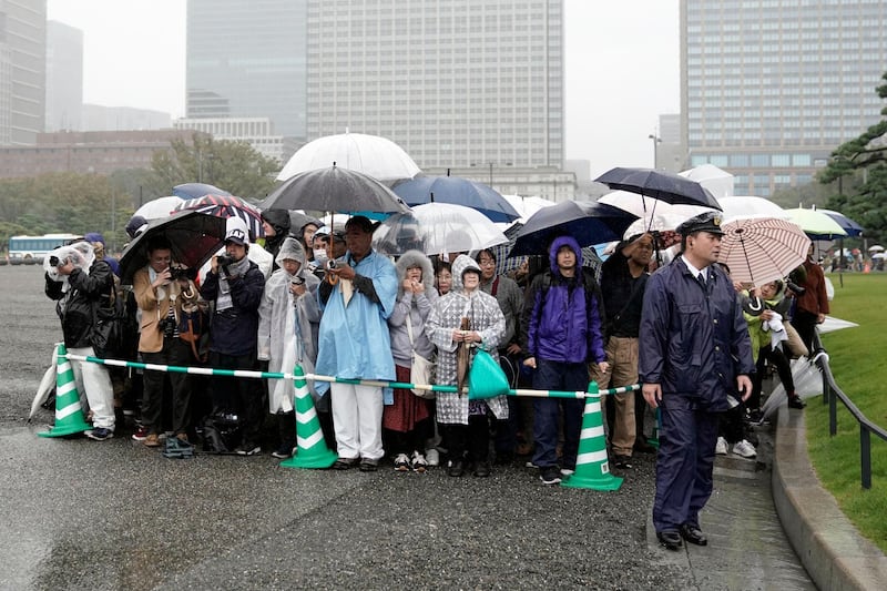 People line up and wait outside of the Tokyo Imperial Palace before before the enthronement ceremony for the 59-year-old Emperor Naruhito, Tuesday, Oct. 22, 2019, in Tokyo, Japan. AP Photo