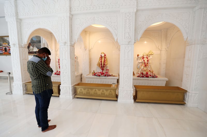 Final touches add a sheen to hand-carved pillars decorated with bells, flowers and elephants, as well as marble floor inlays of emerald and saffron.