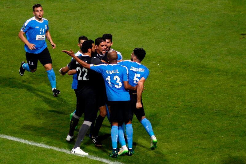 Player of Jordan’s Al Faisaly players clash with Egyptian referee Ibrahim Noor El Din at the end of the Arab Club Championship final against Tunisian side Esperance de Tunis in Alexandria, Egypt, late on Sunday night. Esperance won 3-2. Ahmed And El Gawad / AFP