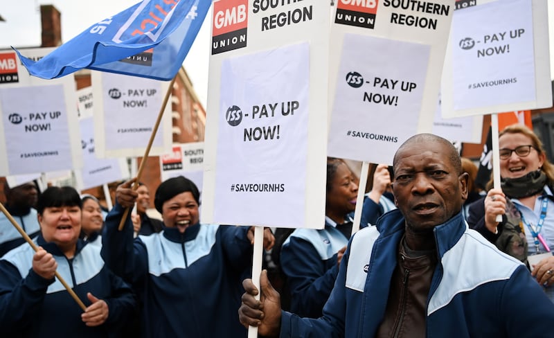 National Health Service cleaning staff hold placards during a strike outside a hospital, in London. EPA