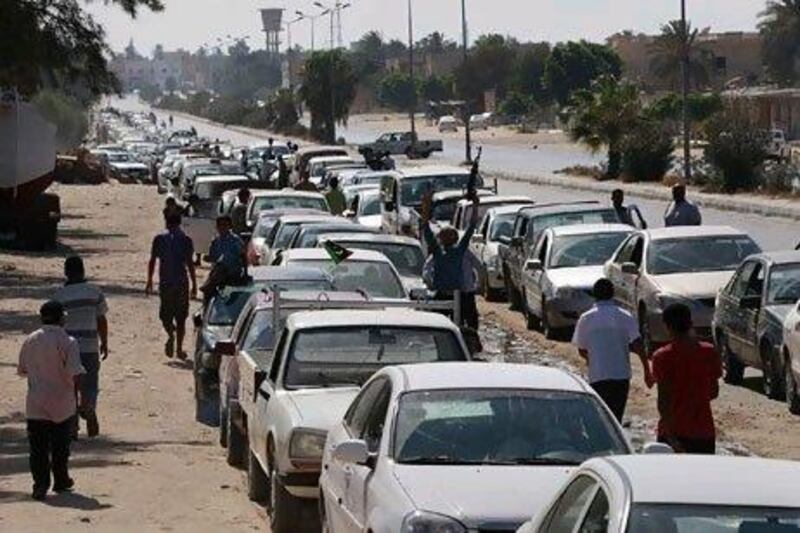 Cars queue up for petrol in the Libyan coastal city of Zawiyah. Libyan rebels tried to ease petrol shortages in the coastal strip west of Tripoli by distributing free fuel.