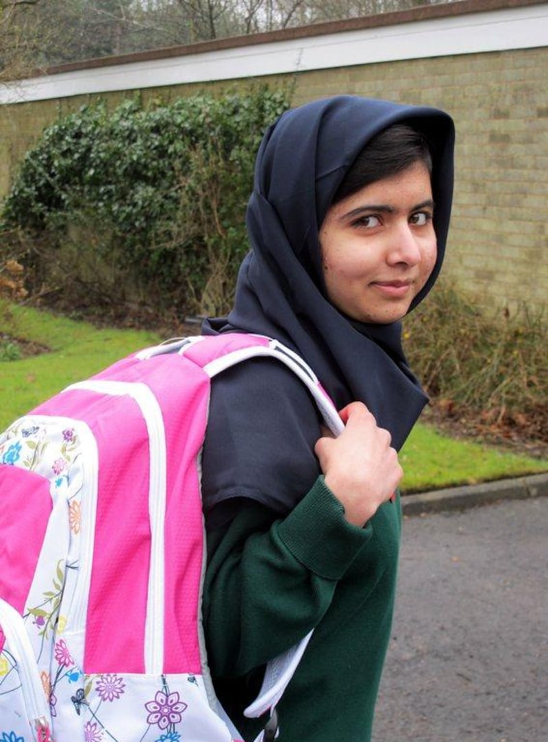 On March 19, 2013, Malala Yousafzai is pictured holding a backpack in Birmingham as she returns to school for the first time. Liz Cave / Malala Press office / AFP Photo