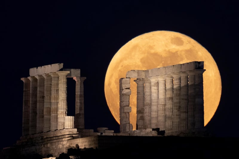 The Super Flower Blood Moon rises over the Temple of Poseidon in Cape Sounion, near Athens, Greece. Reuters