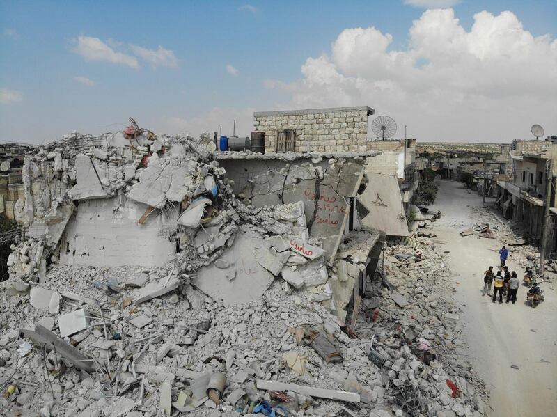 TOPSHOT - A picture taken with a drone on June 14, 2019, shows damaged and destroyed buildings in the town of Ihsim, in Syria’s Idlib region. The Idlib region of some three million people is supposed to be protected from a massive regime offensive by a buffer zone deal that Russia and Turkey signed in September. But it was never fully implemented, as jihadists refused to withdraw from a planned demilitarised zone. / AFP / OMAR HAJ KADOUR

