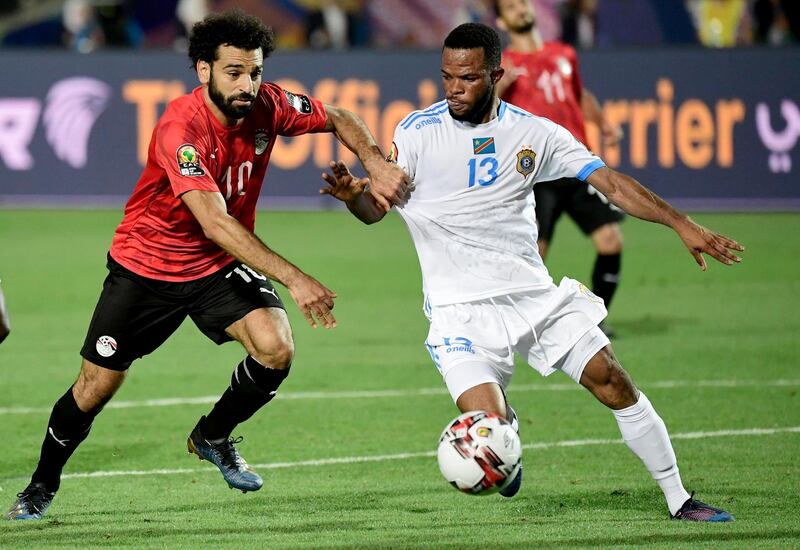 Egypt forward Mohamed Salah, left, fights for the ball with DR Congo forward Elia Meschak. AFP