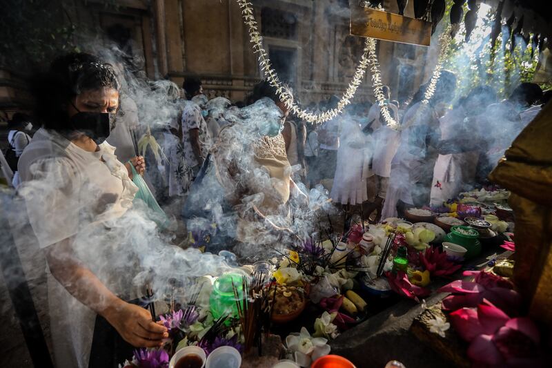 Buddhists offer flowers and incense sticks on Poson full moon day at the Kelaniya temple in Colombo, Sri Lanka. EPA