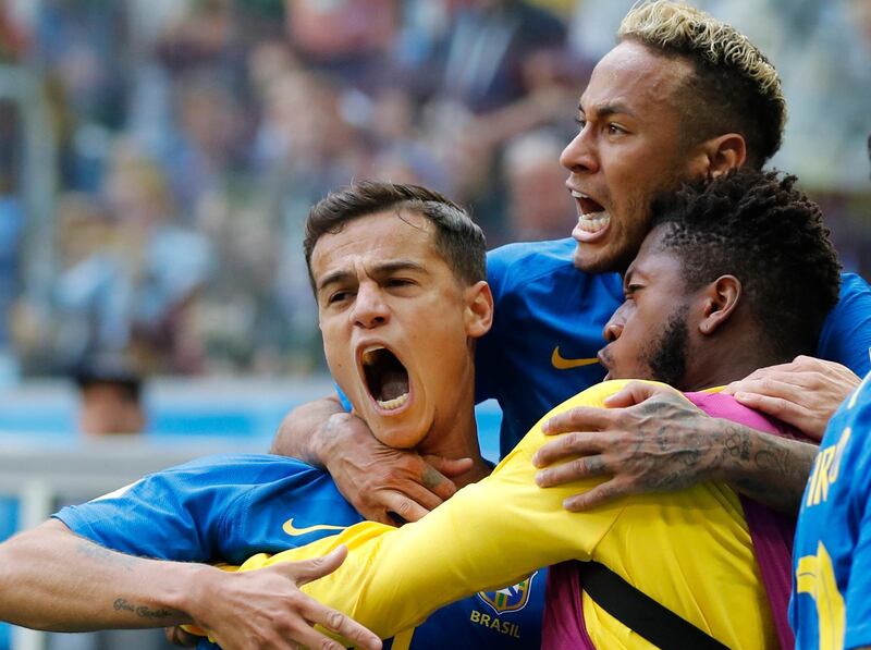 Brazil's Philippe Coutinho, left, celebrates scoring his side's opening goal with Neymar, top, and teammates during the group E match between Brazil and Costa Rica at the 2018 soccer World Cup in the St. Petersburg Stadium in St. Petersburg, Russia, Friday, June 22, 2018. Brazil won 2-0. (AP Photo/Petr David Josek)