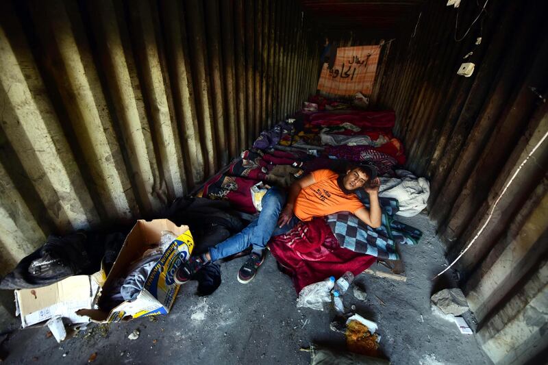 A protester takes a rest inside a container. EPA