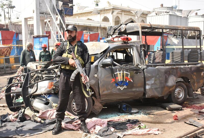 Officials examine the site of the bomb blast. EPA