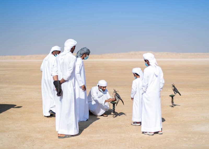 Men practise falconry in the desert at Exit 55, Dubai. Reem Mohammed / The National