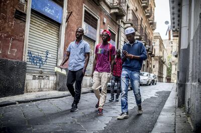 The refugees Mikailou Diallo (L-R), Landing Solly Ameidou Sidy Iraore and Asowe Abdoulie walk after a visit at the community center through Catania in Sicily, Italy, 25 May 2017. Social workers take care of the refugees at the community center. Refugees and other migrants can feel safe and get counselling. The heads of the G7 states meet in Sicily from 26 May until 27 May 2017. Photo by: Michael Kappeler/picture-alliance/dpa/AP Images