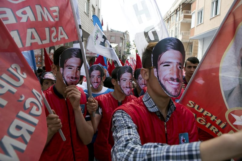Demonstrators in Istanbul, wearing Hasan Ocak face masks, protest this week against forced disappearances. Caleb Lauer