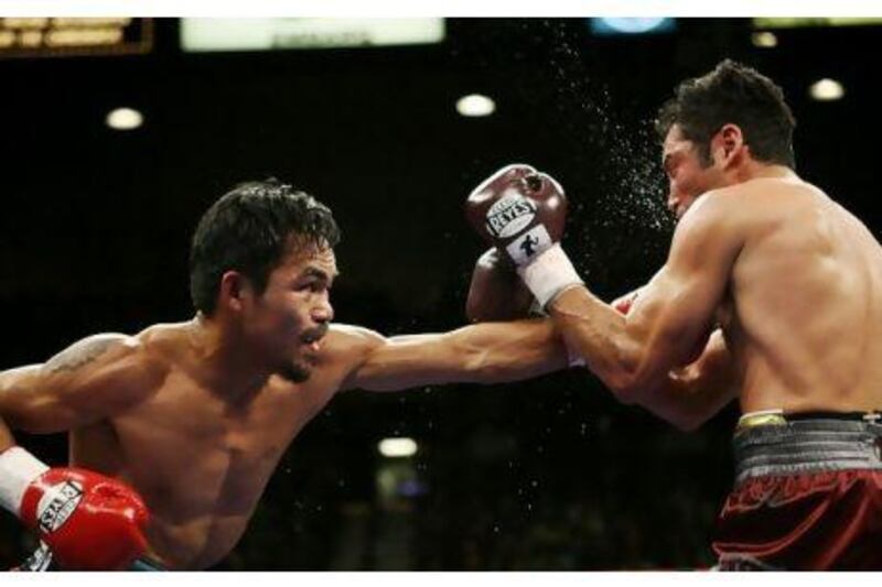 Manny Pacquiao connects on Oscar De La Hoya during their welterweight bout in 2008. Manny won with a TKO in the 8th round.

STEVE MARCUS / REUTERS