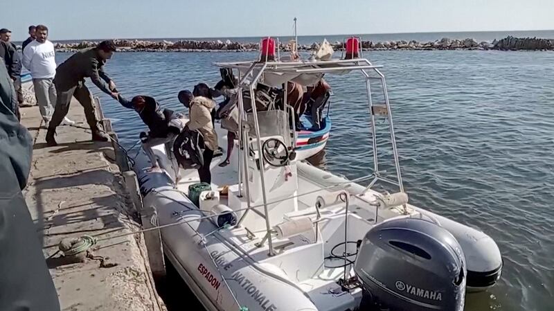 Tunisian coastguard helps migrants off a rescue boat at Jbeniana, near Sfax, in April. Reuters