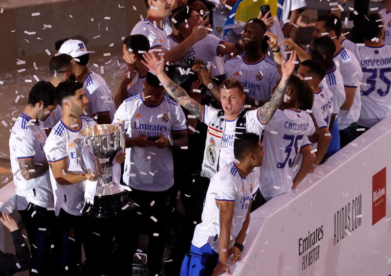 Toni Kroos and his teammates celebrate on top of the bus at Cibeles fountain in Madrid after the club secured the Spanish league title. Reuters