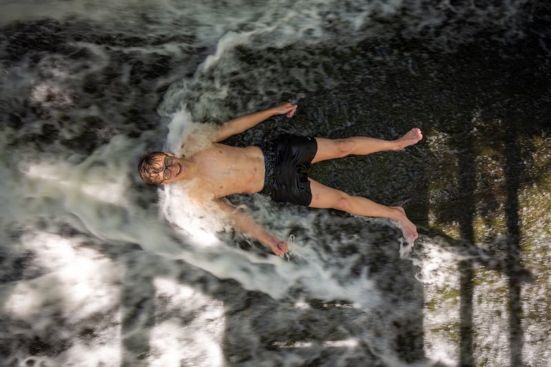 A young man takes a dip in the Peover Eye, a small river that meanders through the Cheshire countryside. Getty Images