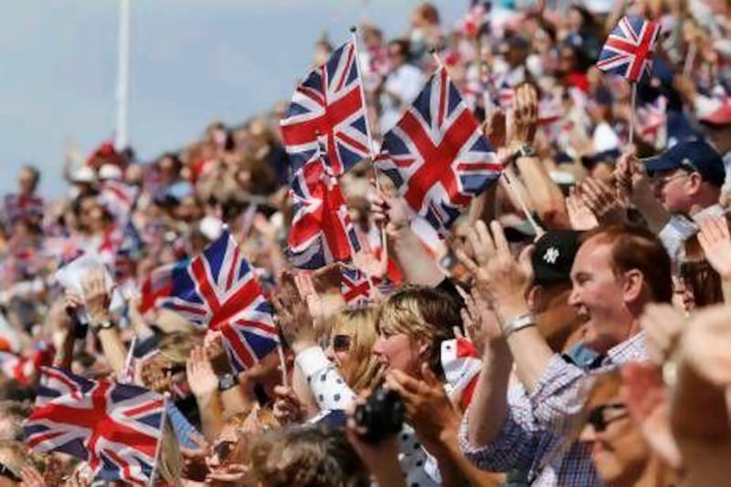 Fans wave Union Jacks during an equestrian individual dressage event in Greenwich Park.