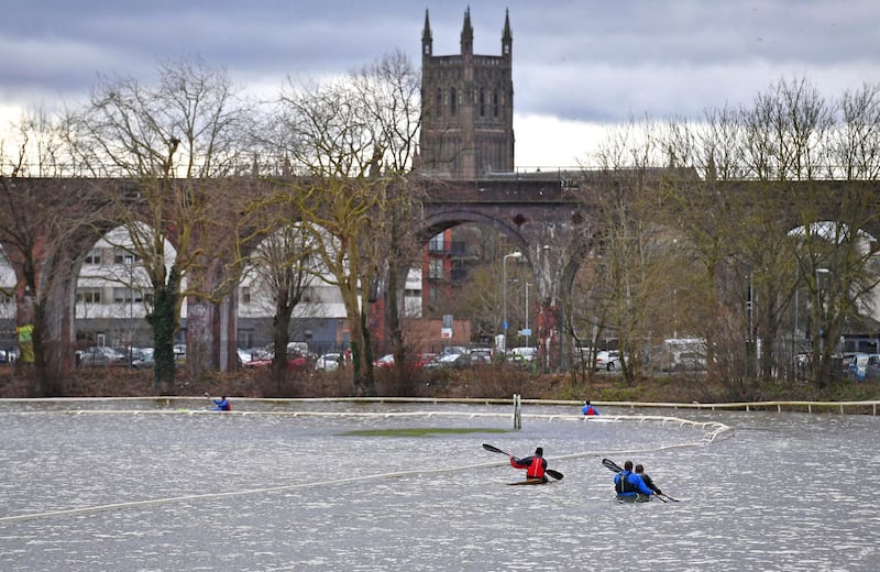 Members of a local canoe club paddle on the flooded Worcester Racecourse in England, on Sunday February 23. AP