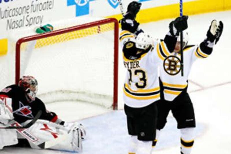 Michael Ryder of the Boston Bruins celebrates his goal with Martin St Pierre against the Carolina Hurricanes.