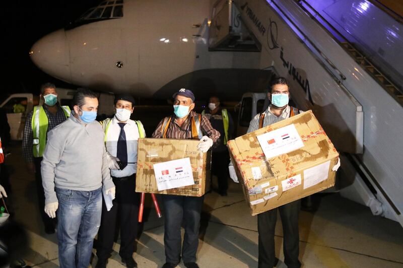 Syrian workers unload medical supplies from China at the International Airport in Damascus, Syria.  EPA