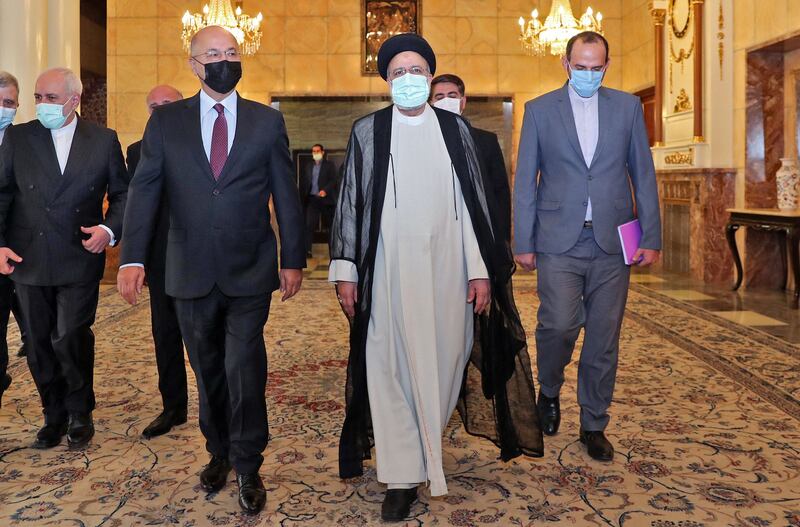 A handout picture provided by the Iranian presidency on August 5 shows President Ebrahim Raisi (centre) receiving Iraq's president Barham Saleh (centre left) in the capital Tehran. AFP