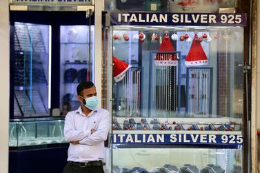 A man waits for customers outside his shop in Bur Dubai on Sunday, January 3, 2021. Chris Whiteoak / The National