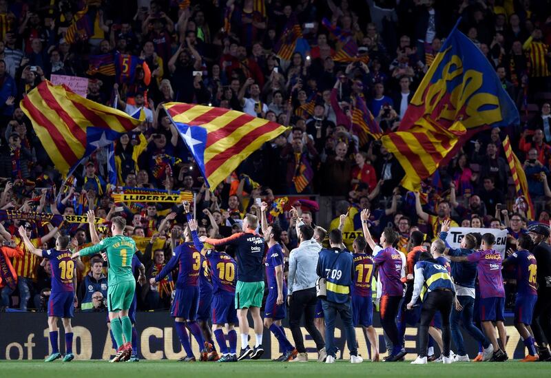 Barcelona players celebrate with fans after the match. Alex Caparros  / Getty Images