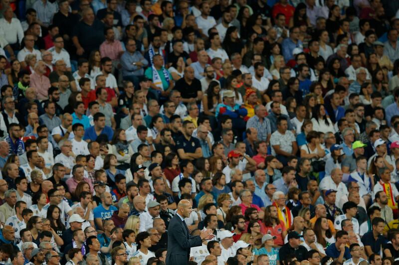 Real Madrid's head coach Zinedine Zidane applauds in front of fans during a Spanish La Liga soccer match between Real Madrid and Espanyol at the Santiago Bernabeu stadium in Madrid, Spain, Sunday, Oct. 1, 2017. (AP Photo/Paul White)