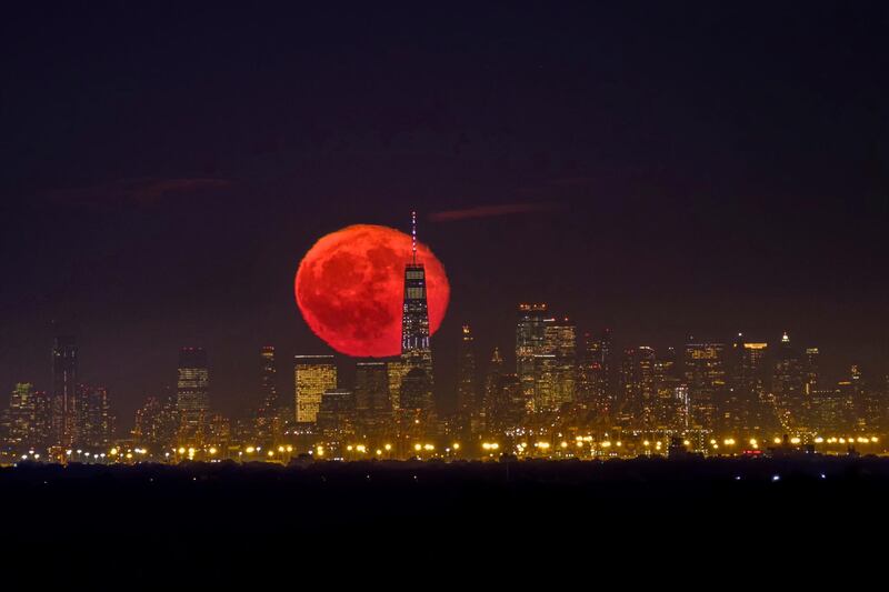 The moon rises behind One World Trade Centre on a clear night in the Lower Manhattan neighbourhood of New York.  AP