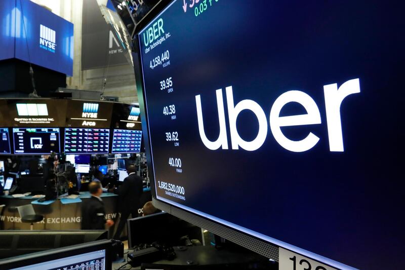 The logo for Uber appears above a trading post on the floor of the New York Stock Exchange, Thursday, May 30, 2019.   (AP Photo/Richard Drew)