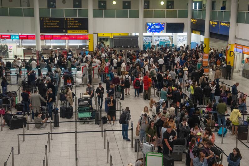 People wait near check-in desks at Gatwick Airport. Getty Images