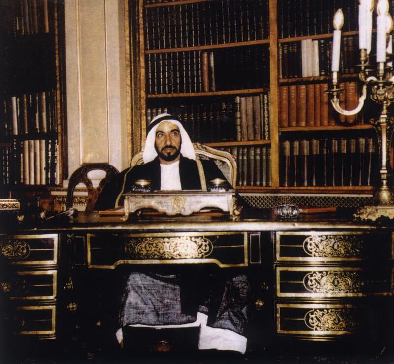 Sheikh Zayed, in a rare moment at his desk, on the second anniversary of his accession.