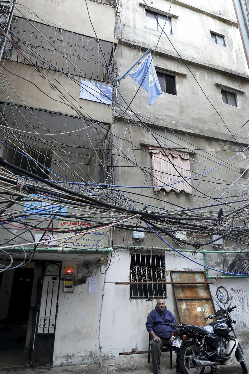 A Palestinian refugee sits at the entrance of the UNRWA offices in the Burj al-Barajneh camp in the Lebanese capital Beirut on January 17, 2018. - The UN agency for Palestinian refugees warned it faced its worst funding crisis ever after the White House froze tens of millions of dollars in contributions, a move Palestinian leaders decried as cruel and blatantly biased. (Photo by JOSEPH EID / AFP)