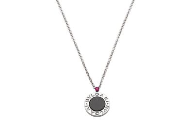 Bulgari's disc-like Save the Children pendant in sterling silver and onyx, topped with a red ruby from Mozambique. Courtesy Bulgari