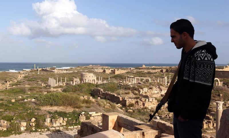 A Libyan man stands guard in the ancient Roman city of Leptis Magna in Al Khums. Mahmud Turkia/AFP