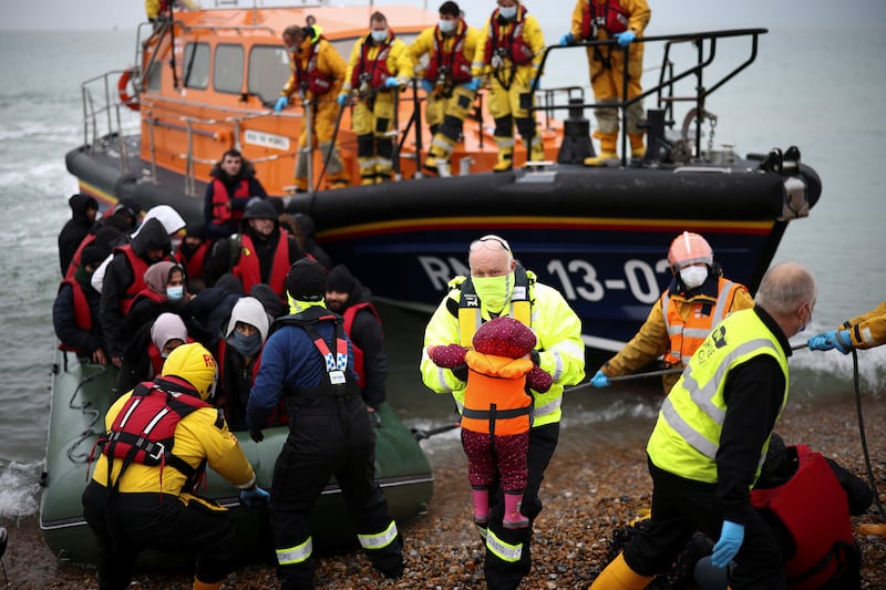 Migrants are brought ashore at Dungeness by RNLI Lifeboat members after crossing the Channel. Reuters