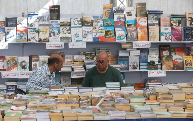 Two men rummage through some of the books on display.