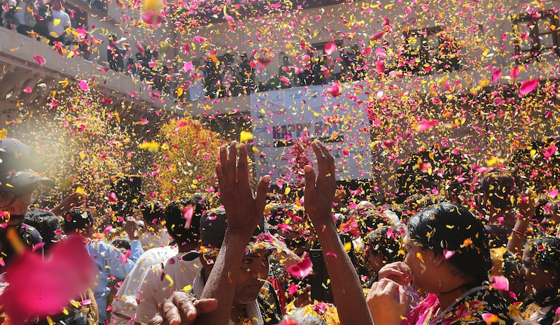 Widows throw petals while participating in Holi festivities in Vrindavan, Uttar Pradesh. EPA
