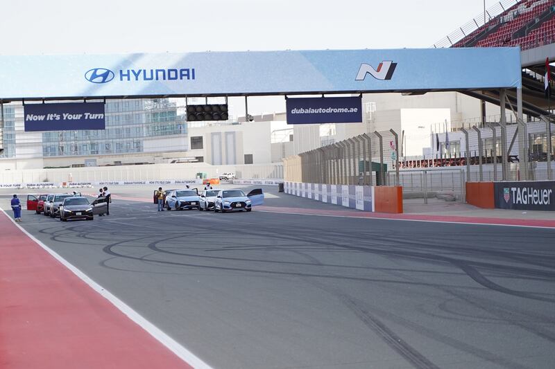 The drivers swap vehicles on Dubai Autodrome's main straight.